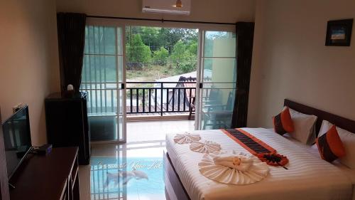 a bedroom with a bed with flowers on it at Baramate Khao Lak - SHA PLUS in Khao Lak