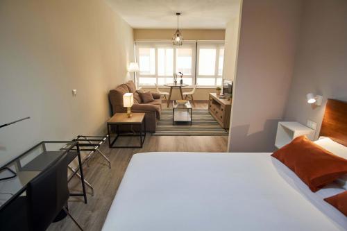 Ένα ή περισσότερα κρεβάτια σε δωμάτιο στο Apartamentos Los Arroyos
