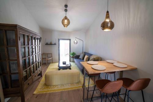 - un salon avec une table et un canapé bleu dans l'établissement CASA VALDES 16, APTO 3, à Cáceres