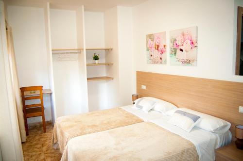 מיטה או מיטות בחדר ב-Complejo Turistico la Pinada