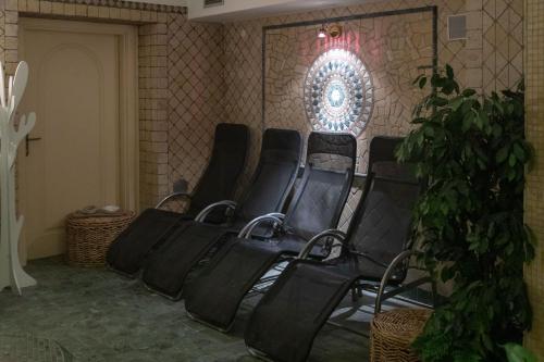 a group of chairs in a room with a wall at Hotel Compagnoni in Livigno