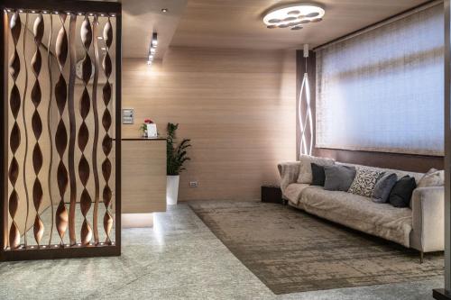 a living room with a couch and a window at Hotel Compagnoni in Livigno