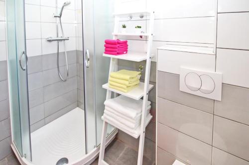 a white towel rack with towels on it in a bathroom at Apartment Mihaela in Baška