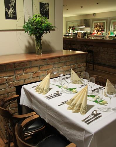 a table in a restaurant with a white table cloth at Hotel Bothe in Považská Bystrica