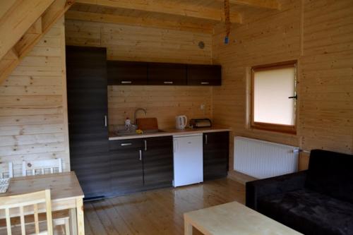a room with a kitchen and a living room at Agroturystyka Stajnia Zwierzyniec in Międzychód