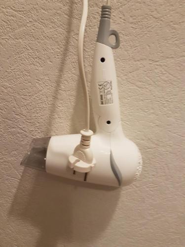 a wii remote control hanging on a wall at Hotel Erfolg in Daugavpils