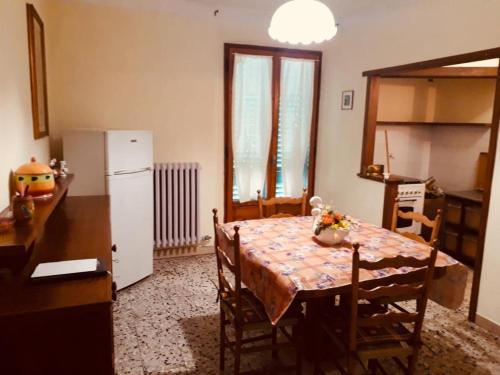 a kitchen with a table and a table and a refrigerator at Casotti in Cutigliano