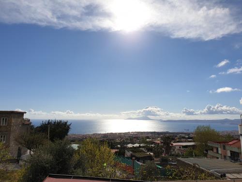 a view of the ocean from a city at B&B Incanto in Ercolano
