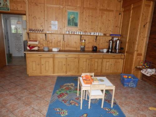 a kitchen with a counter and a table in a room at Hotel Stara Skola in Sloup