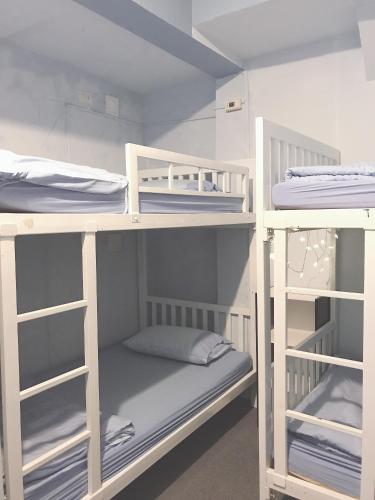 a room with three bunk beds in a room at 1sabai in Bangkok