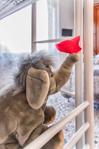 a stuffed monkey holding a red heart in a window at MADI' casa vacanze in Laiatico