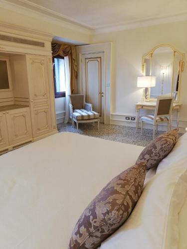 a bedroom with a large white bed in a room at Ca' Bonfadini Historic Experience in Venice