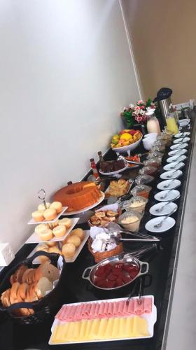 a long table filled with different types of food at Vyalle Hotel in Machadinho