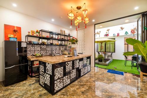 a kitchen with a counter in a room at Sunny Riverside Homestay in Hoi An