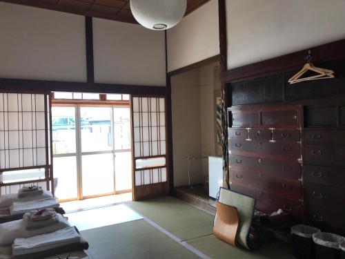 a room with a room with a door and a room at Traveler's Wharf Shichigahama in Shichigahama