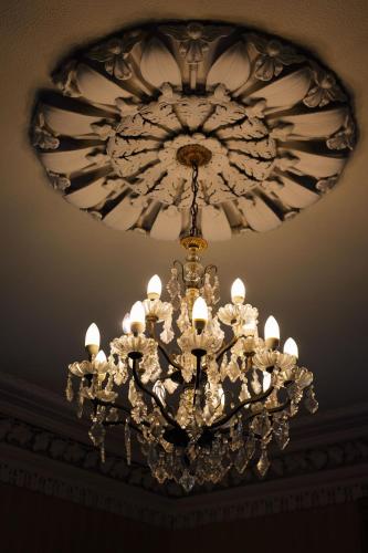 a large chandelier hanging from a ceiling at Elm Grove Country House in Tenby