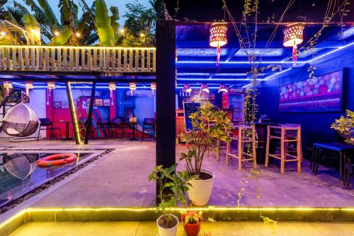 a view of a bar with tables and chairs at Sunny Riverside Homestay in Hoi An
