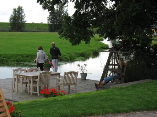 a group of people standing on a deck near a river at Piaam State in Piaam