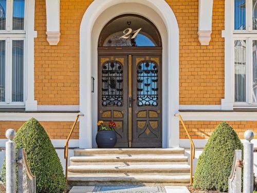 a front door of a house with a vase on the stairs at Villa Sommerfreude in Bansin