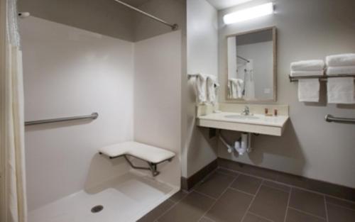 a bathroom with a sink and a toilet and a mirror at Coast Hilltop Inn in Pullman