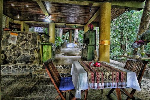 a dining room with a table and some chairs at Waterfall Villas in Dominical