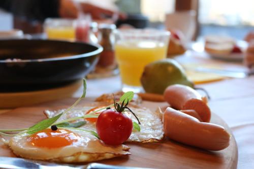 a plate of food with tomatoes and other foods on a table at Pension Lectar in Radovljica