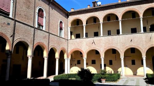 a large brick building with columns and arches at ARIOSTEA Ap.1 in Ferrara