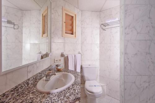 a white bathroom with a sink and a toilet at MLL Blue Bay in Palma de Mallorca