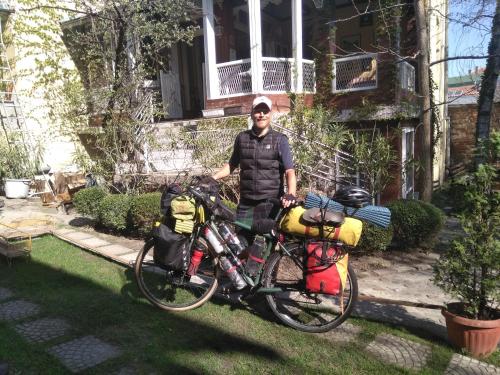 a man is standing next to a bike at Base for Adventurers - Urban Guerrilla in Negotin