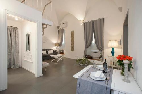 a white living room with a table and a couch at La Casa Bianca in Florence