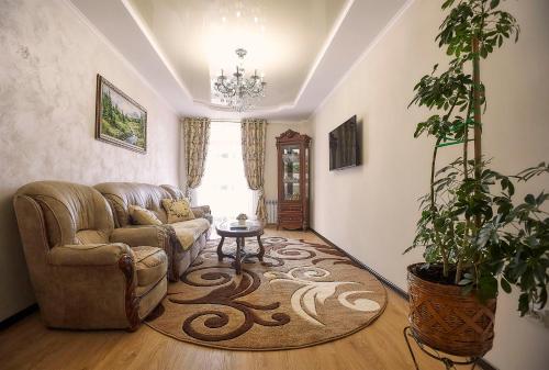 a living room with a couch and a table at Luxury Apartament 2 in Truskavets