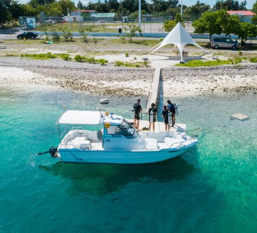 a group of people standing on a boat in the water at WAVE SOUND by 3S Maldives in Maradhoofeydhoo