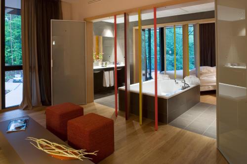 a living room with a large mirror and a bathroom at Restaurant Hôtel L'Arnsbourg in Baerenthal
