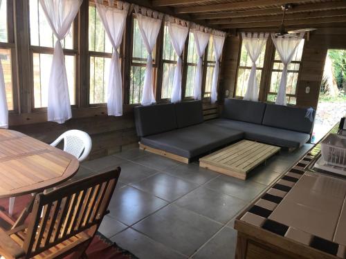 a living room with a couch and a table at Roatan Bed & Breakfast Apartments in West End
