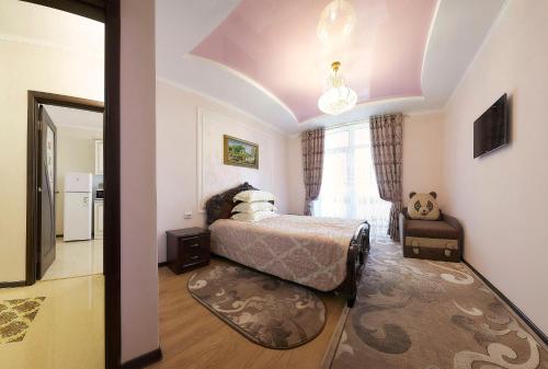 a bedroom with a bed and a large window at Luxury Apartament 2 in Truskavets