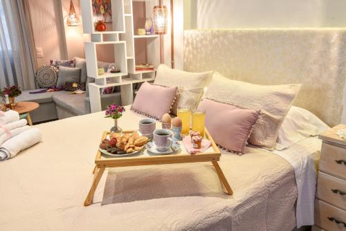 a room with a bed with a tray of food on it at Suite 16 in Corfu