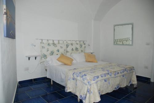 a bedroom with a white bed with two pillows on it at B&B Dimora San Vincenzo in Gallipoli
