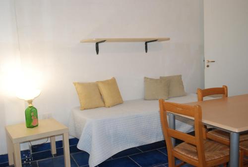 a bedroom with a bed and a table and a table and chair at B&B Dimora San Vincenzo in Gallipoli