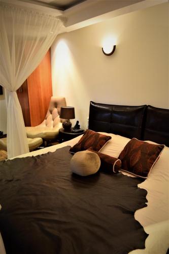 a bedroom with a large bed with a black headboard at Ikala Quito Boutique Hotel in Quito