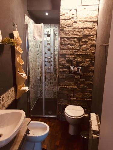 a bathroom with a shower and a toilet and a sink at Casa tipica siciliana patronale home BedandBreakfast TreMetriSoprailCielo Camere con vista, colazione interna in terrazzo panoramico in Caltagirone