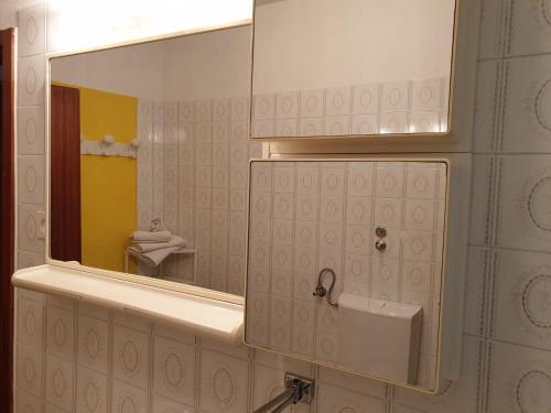 a bathroom with a mirror and a sink at Apartments and Rooms Dobrila in Jelsa