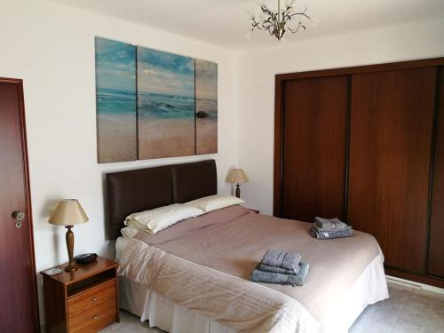 a bedroom with a bed with two towels on it at Casa Marc in Carvoeiro