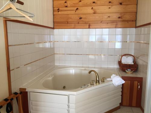 a bath tub with a sink in a bathroom at Captain's Choice Motel in Haines