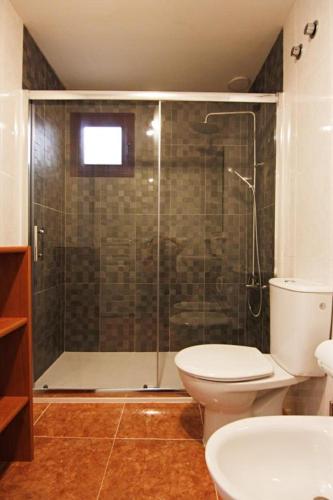 a bathroom with a shower with a toilet and a sink at La Perla de Bahia Sol in Caleta De Fuste