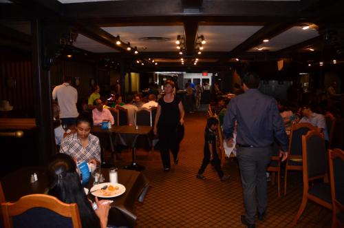 a woman walking through a room full of people at Hotel Royal Plaza in Winnipeg