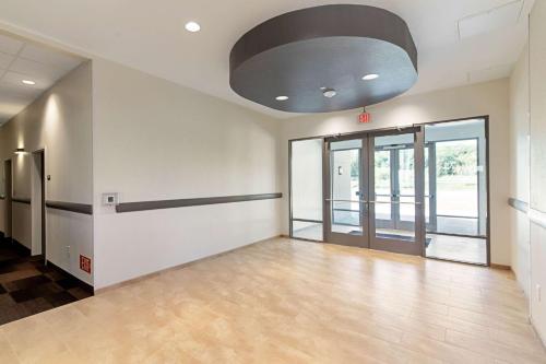 an empty office lobby with a large ceiling at Motel 6 Austin Airport in Austin