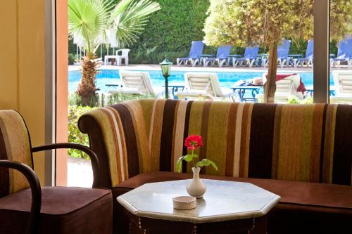 a table with a vase with a flower on top of it at Chems Hotel in Marrakech