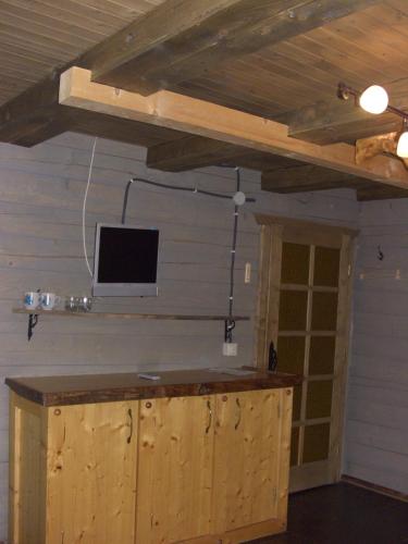 a room with a counter with a tv on the wall at Chalet Truten in Vorokhta