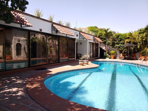 a swimming pool in the middle of a house at Quinta Don Jose Boutique Hotel in Guadalajara