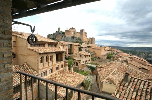 a view of a town with a castle in the background at Casa Avellanas in Alquézar